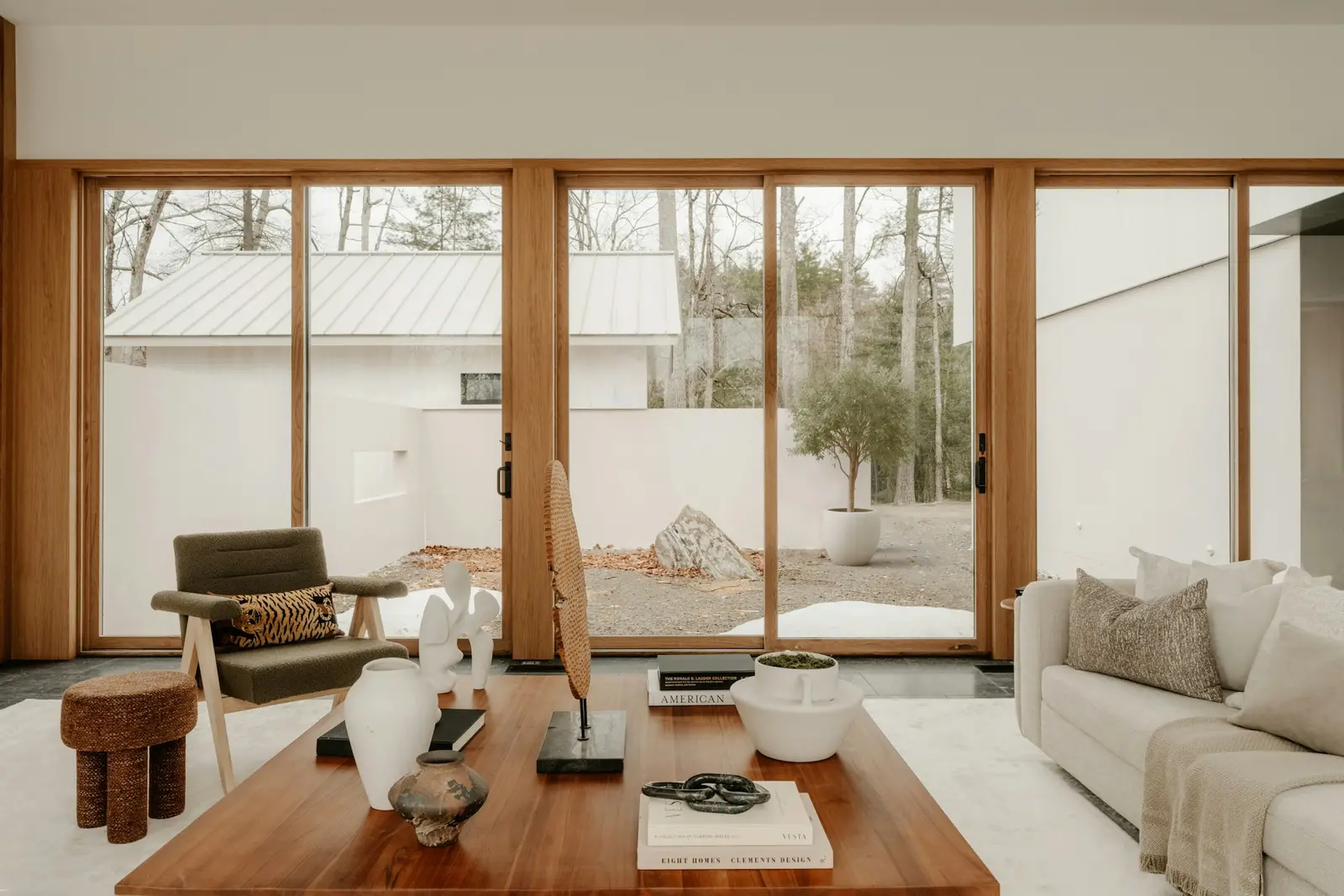 Sala luminosa con puertas corredizas de vidrio del piso al techo